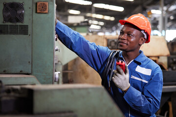 technician or foreman fixing machine and talking on walkie talkie in the factory