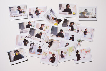 collection of Polaroid photos scattered across a white surface, each frame capturing different facets of a young entrepreneur's work life, from planning to execution.