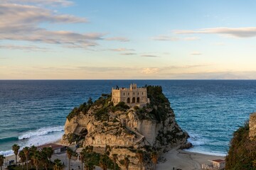 Fototapeta na wymiar view of the Santa Maria dell'Isola Church on its rocky promontory in Tropea at sunset