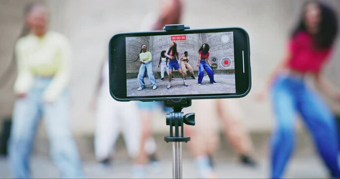 Dance on social media, live streaming or group of friends or people with influencers or content creator. Music, group or video broadcast with fun women in city for post, film or screen on mobile app