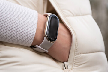 One hand in a pocket with smart watch on a wrist