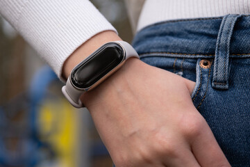 Smart watches on a wrist with hand in a pocket