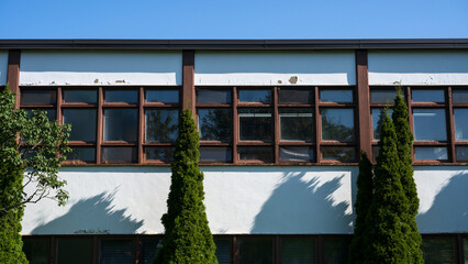 A damaged school wall on a blue sky