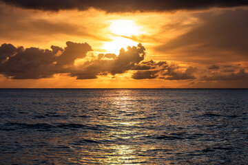 Fototapeta premium Paynes Bay Beach, Barbados: boats sailing during an amazing colorful sunset in the caribbean sea.