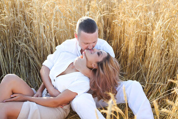 Happy couple in love in wheat field