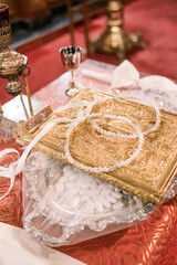 Greek orthodox wedding headbands on the holy book.