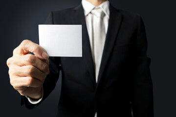 Communication in business circles. ,Announcement of news. ,Businessman holding a white paper note