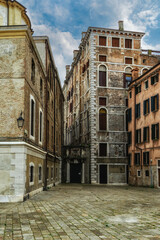 Fototapeta premium Facades of weathered buildings with windows on street of Venice city