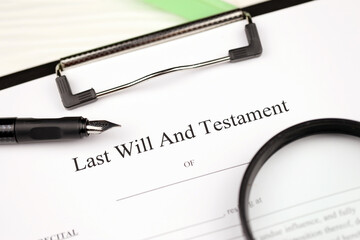 Last Will and testament blank document on A4 tablet lies on office table with pen and magnifying...
