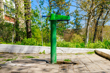 Outdoor pump with drinking water. Background with selective focus and copy space