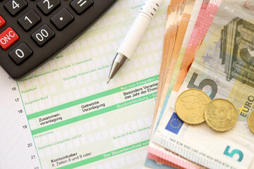Filling greman tax form process with pen and euro money bills close up. Tax paying period and deadline