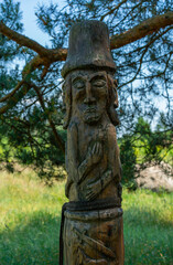 Fototapeta na wymiar wooden pagan slavic gods totem pole - ancient monument folk ritual symbol in forest