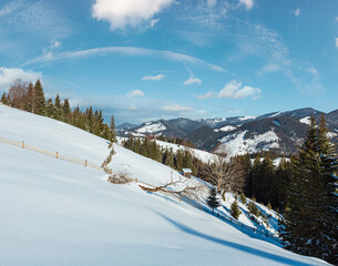Fototapeta na wymiar Winter mountain rural snow covered hill slope