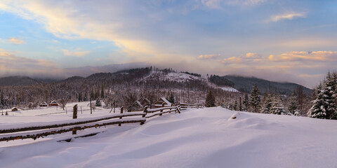 Fototapeta na wymiar Countryside hills, groves and farmlands in winter remote alpine mountain village