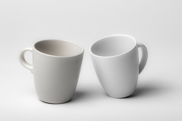 Mockup of a two different coffee cups, isolated, on a plain background, ready to overlay designs or logos for merchandising