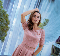 A Woman Posing in a Pink Dress. A woman in a pink dress posing for a picture