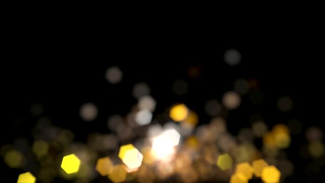 A seamless sparkling 4K looped animation of Gold Silver and White hexagonal lens bokeh lights against a black background. Lens flare, glittering, new years concept.