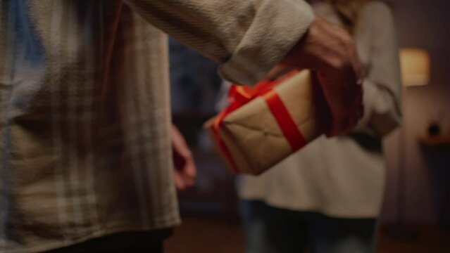 Boyfriend presenting gift box to girlfriend at evening time