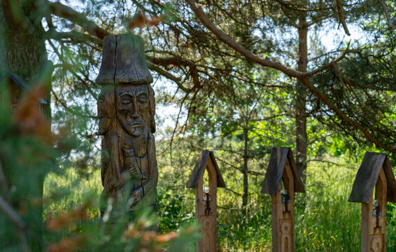 Sacred grove Slavic Native Faith wooden pagan totem pole of Svetovit god deity in forest Poland