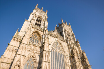 Exterior of York Minster cathedral against a blue sky, York, UK