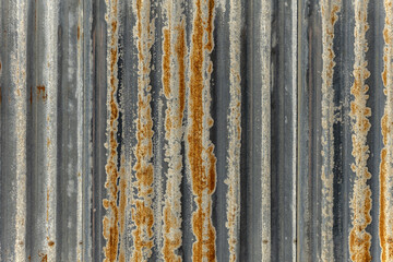 A wall covered in rusty corrugated metal. Vector metal texture background