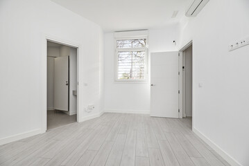 A room in a loft-style house on the ground floor with light wooden floors,