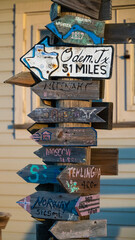 Directional sign post pointing the various cities around the world including locations in Texas,...