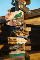 Directional sign post pointing the various cities around the world including locations in...