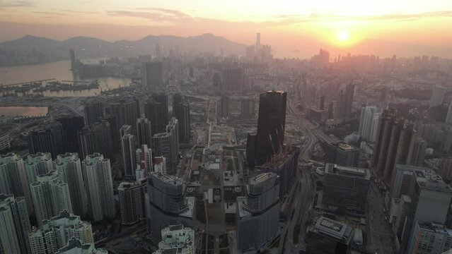 Seaside commercial and residential construction project in Kai Tak Sports Park Cruise Terminal Hong Kong Kowloon city, Kwun Tong and Kowloon Bay near Victoria harbor, Aerial drone sunset dust gloaming