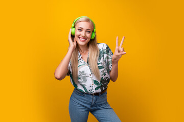 Portrait of optimistic positive woman with straight hair wear print blouse touch earphones show...