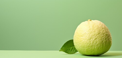 A fresh pomelo, side-angle, realistic in Agfa Vista 400 style, against a light green backdrop, with...