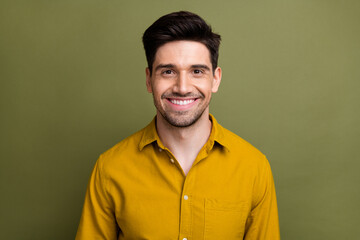 Portrait of cheerful successful young corporate man beaming smile isolated on khaki color background