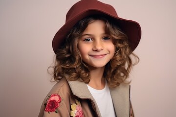 Portrait of a beautiful little girl in a hat and coat.