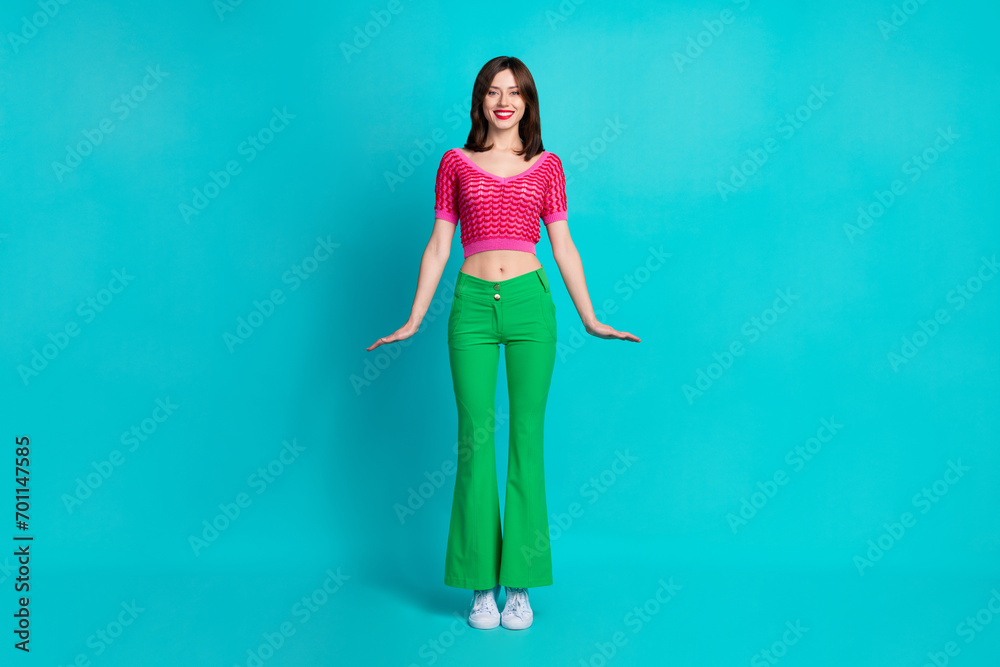 Poster full length photo of adorable cute friendly woman dressed knitwear top green pants standing like dol