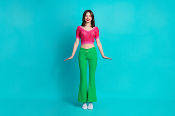 Full length photo of adorable cute friendly woman dressed knitwear top green pants standing like...