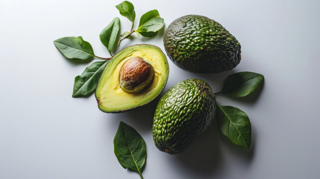 A composition of whole and halved avocados surrounded by fresh leaves, creating a refreshing and healthy vibe. The image captures the essence of natural, wholesome eating.
