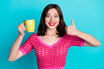 Photo of positive girl hold cacao mug make fine gesture enjoying aroma isolated over blue color...