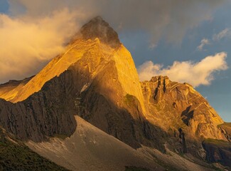 Fototapeta premium High mountain peak surrounded by clouds