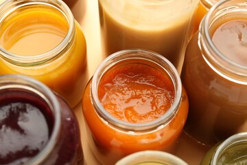 Jars with healthy baby food on table, closeup