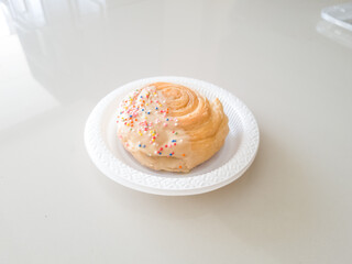 Crispy pastry filled with sweet strawberry jam in a container on a white background