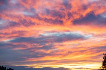 Idyllic blue sky and orange and multicolored clouds