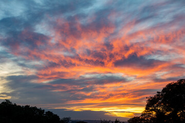 Idyllic blue sky and orange and multicolored clouds