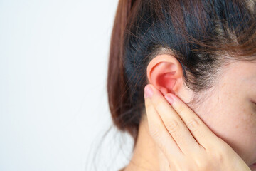 Woman holding her painful Ear. Ear disease, Atresia, Otitis Media, Inflation, Pertorated Eardrum,...