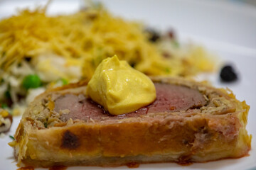 Traditional and Perfect homemade juicy Beef Wellington, tenderloin dish on rustic wooden table. Christmas food