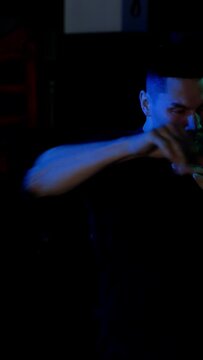 Male boxer makes strong and fast punches.