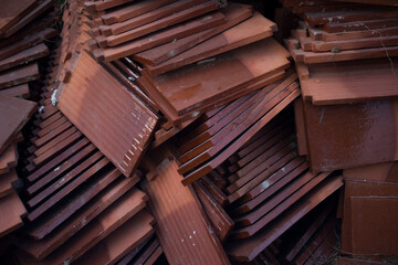 A pile of roof tiles in a construction site, closeup of photo - obrazy, fototapety, plakaty