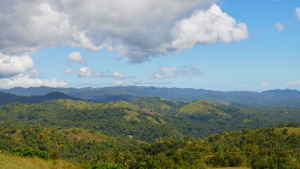 panoramic view of a tropical island, mountains, forest, clouds