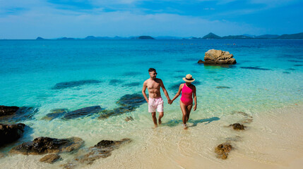 A couple of men and woman at Ko Kham tropical Island Sattahip Chonburi Samaesan Thailand