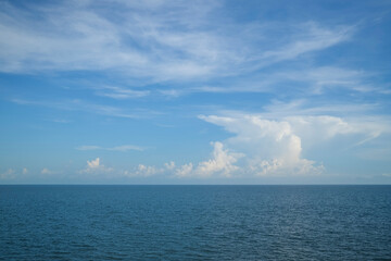 Naklejka na ściany i meble Seascape with sky and white clouds