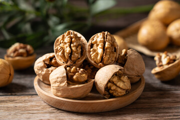 Walnuts are placed on a rustic old wooden table